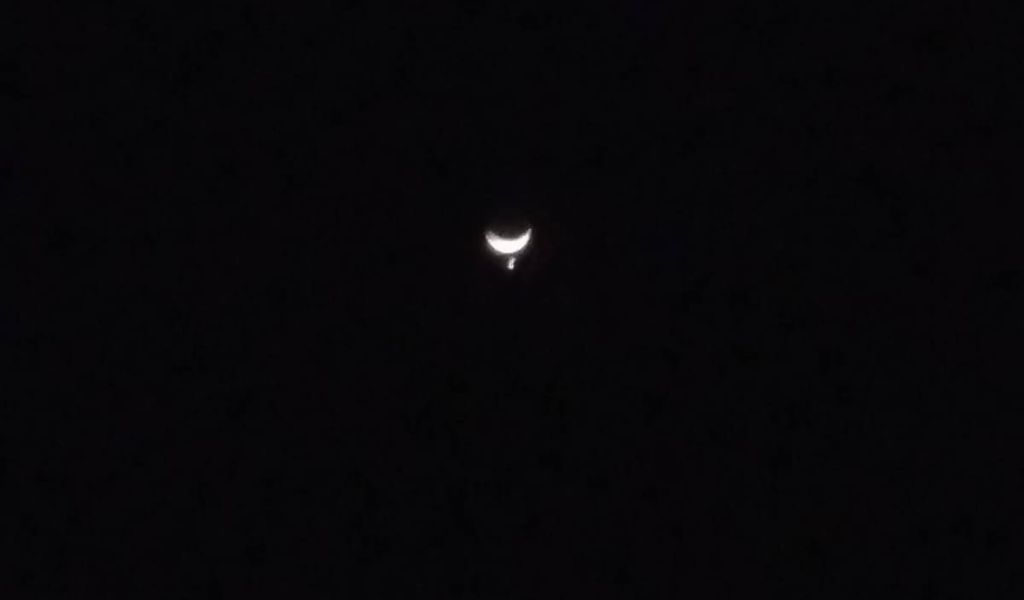 Venus disappears behind the Moon
