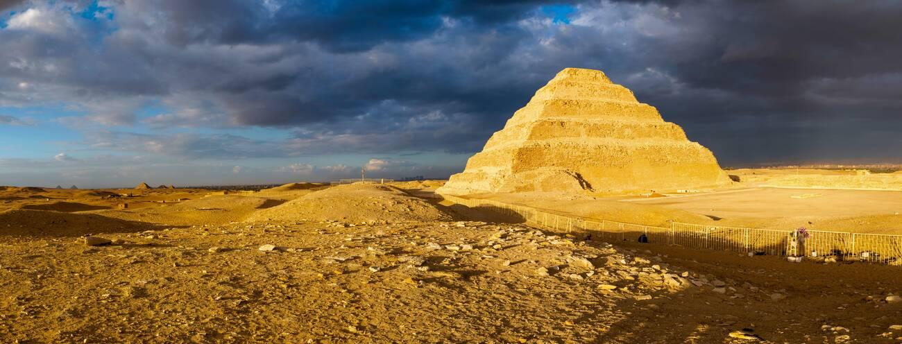 Stepped Pyramid of Djoser against storm clouds, Saqqara, Al Badrashin, Giza Governate, Egypt