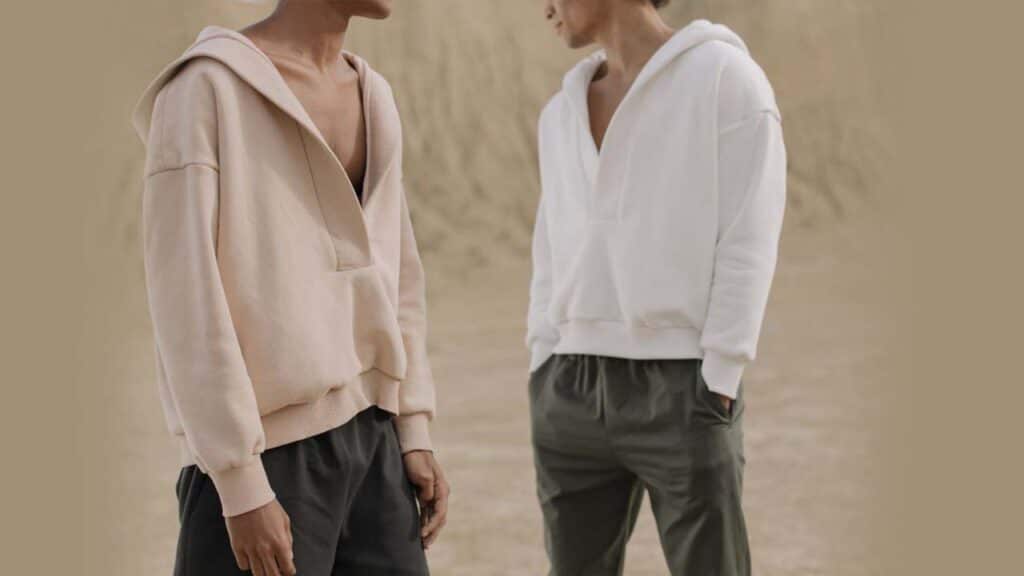 Two men in casual hoodies and pants standing