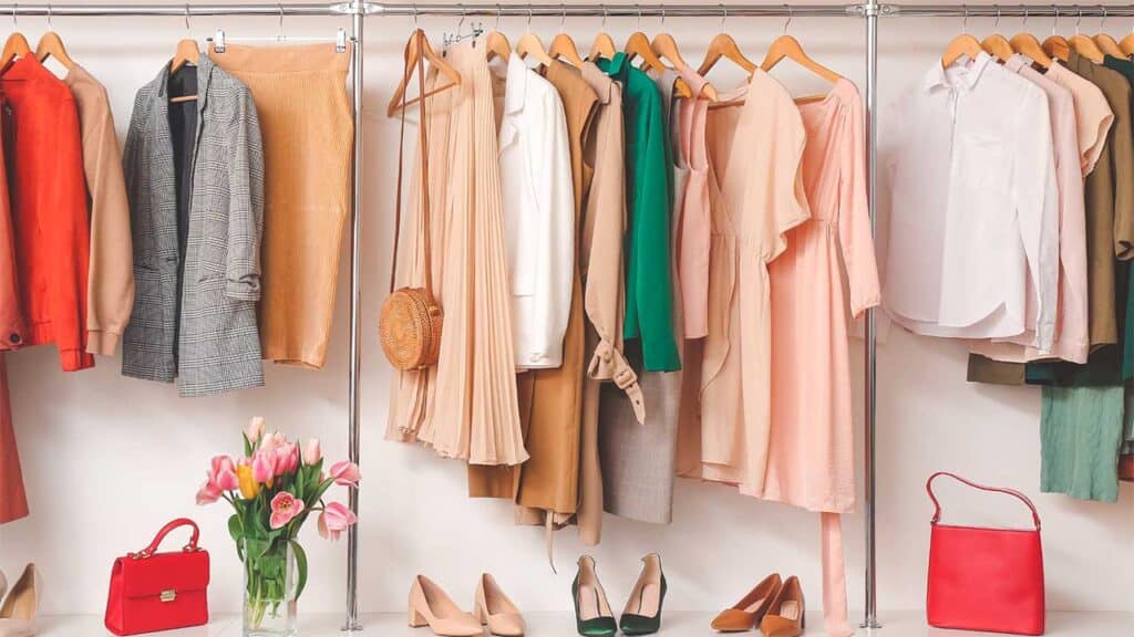 Stylish clothing and accessories neatly organized in a closet.