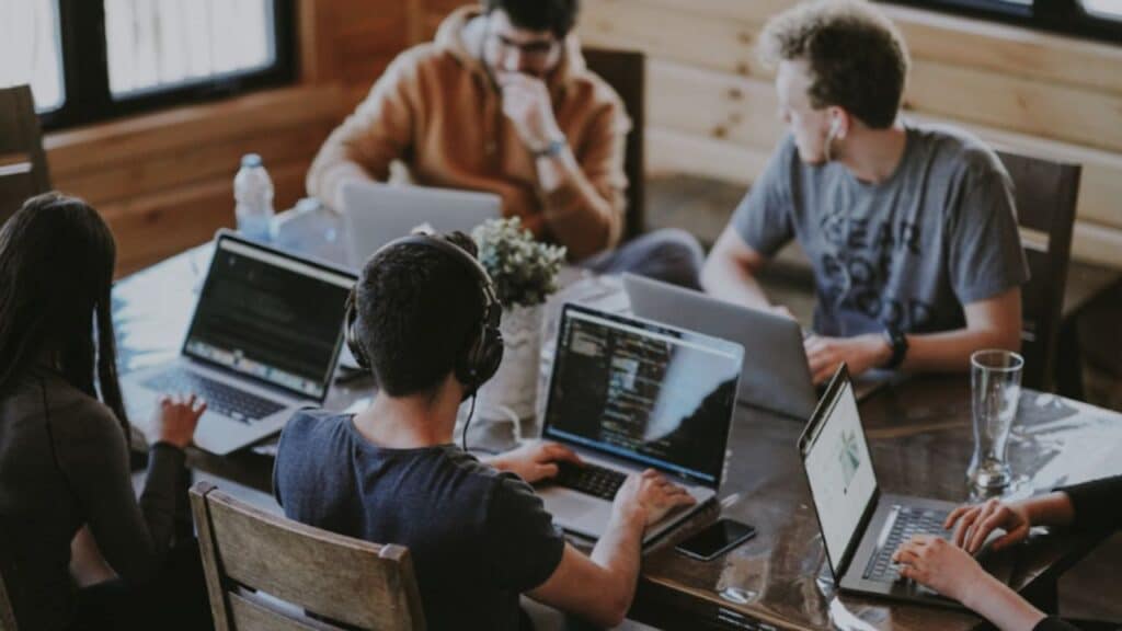 Team collaborating using cloud knowledge management software to streamline